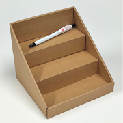 Cardboard display stand with a pen on a white background